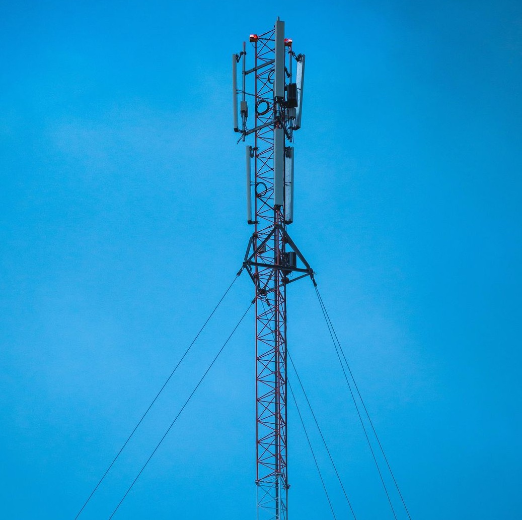 a tall tower with a cell phone on top of it